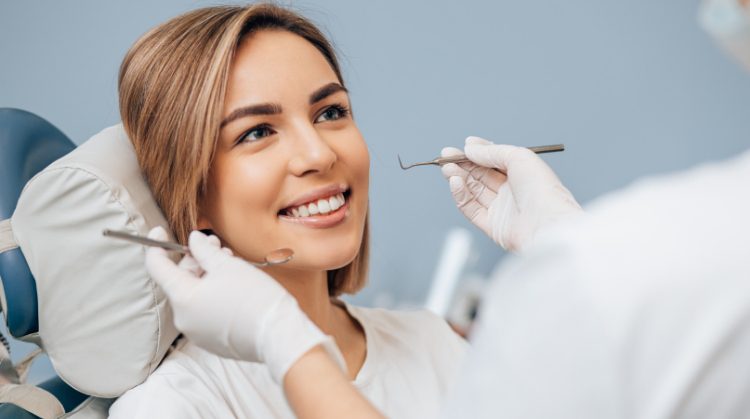 Woman smiling during a preventive dentistry checkup.